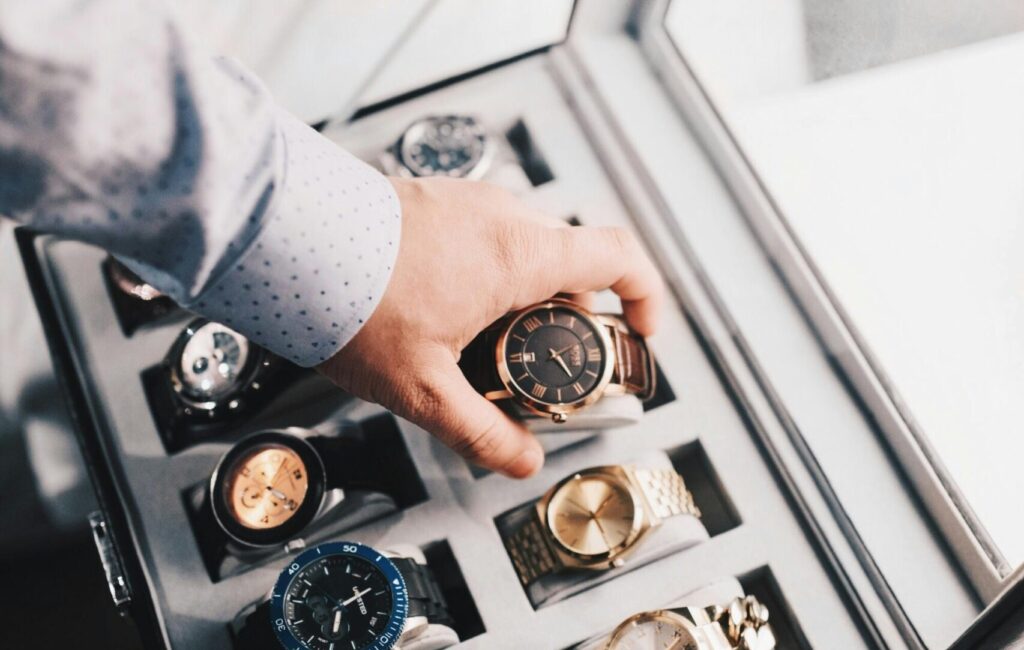 Person Holding Round Gold-colored Analog Watch With Link Bracelet